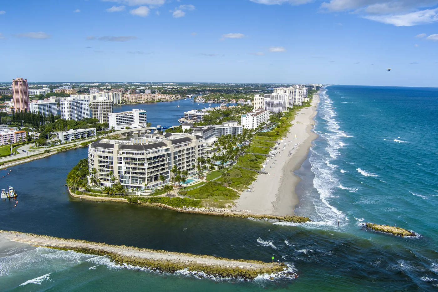 The jetty at Boca Inlet with the beach and condominium towers curving away north