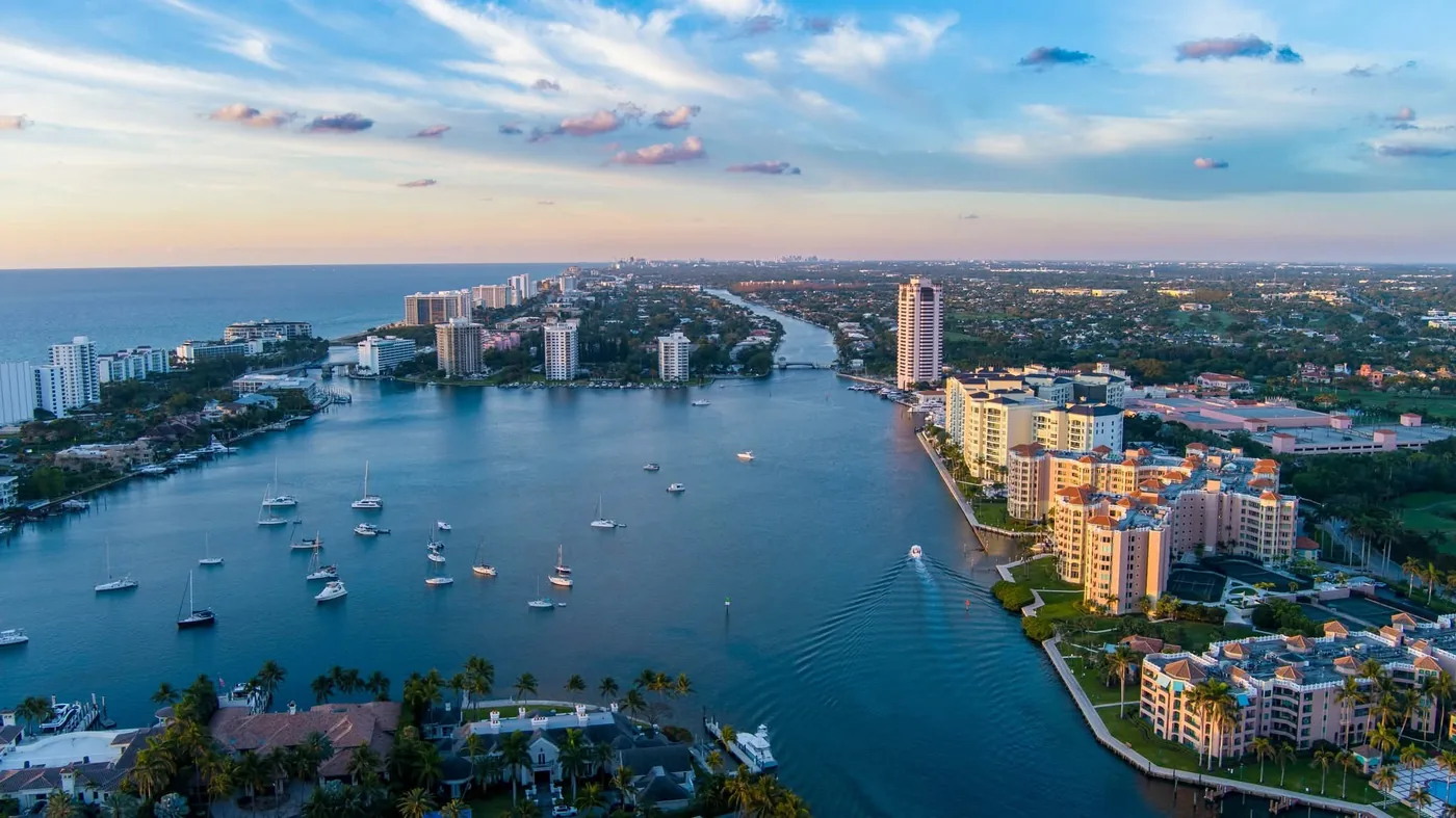 Sailboats anchored on the Intracoastal at sunset with the Boca Raton skyline along the water