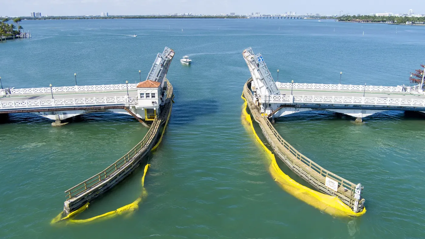 A drawbridge caught fully open, both leaves raised over the channel