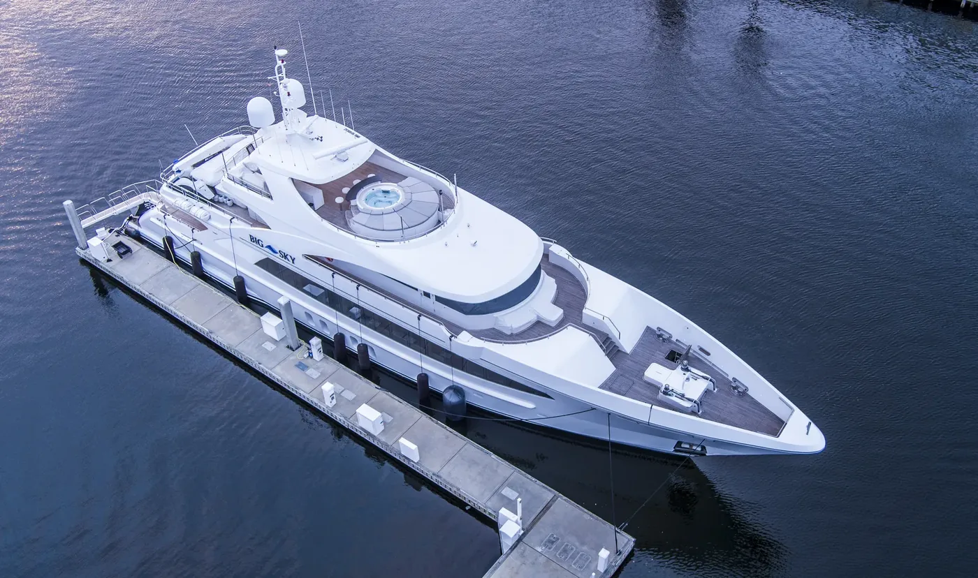 A superyacht alongside, shot from directly overhead against dark water