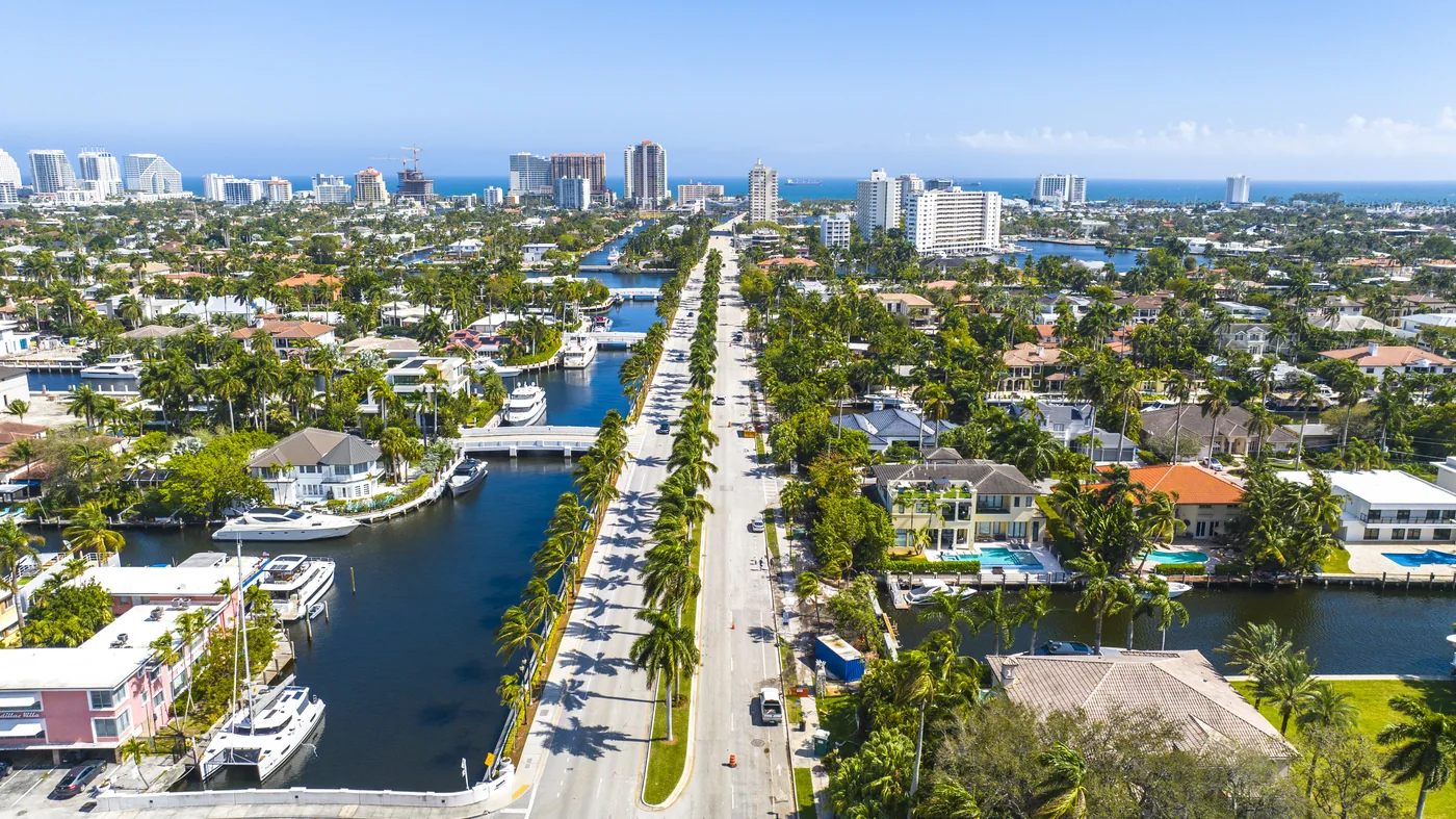 Las Olas Boulevard running straight toward the ocean between two canals lined with docked boats