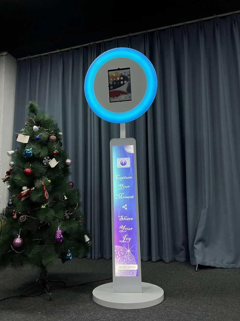 Photo booth set up beside a Christmas tree at a South Florida event
