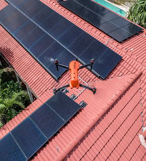 Drone hovering over rooftop solar panels during an inspection