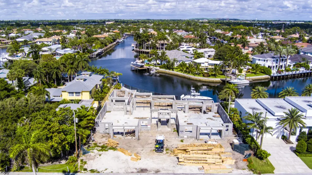 Drone view along a residential canal lined with docks in South Florida